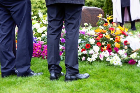 Standing next to a grave